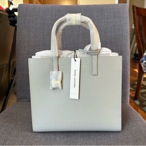 Marc Jacobs light grey crossbody tote 
Dimensions: 8" x 9" x 4" New